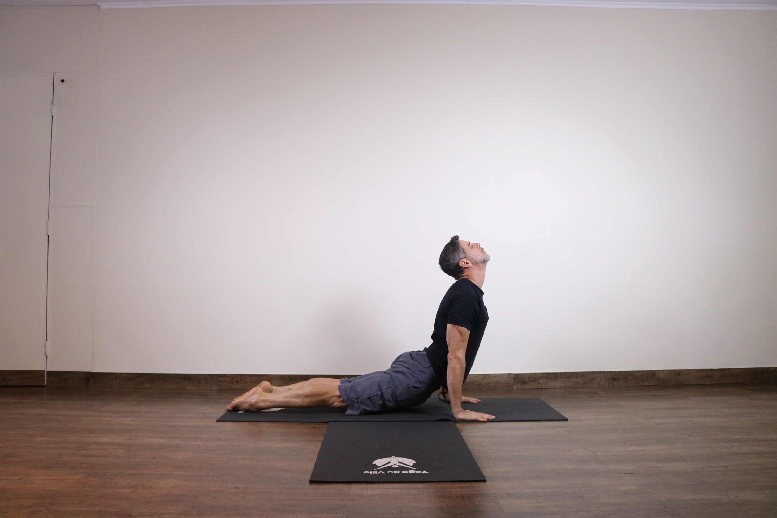 Professor Márcio demonstrando a postura Bhujangasana (postura da cobra) no estúdio Yoga du Ville na Tijuca, Rio de Janeiro.